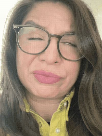 Woman Wearing Glasses And Yellow Shirt Making Funny Face GIF