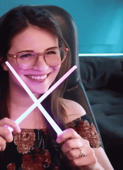 Woman Wearing Glasses Holding Glow Sticks GIF