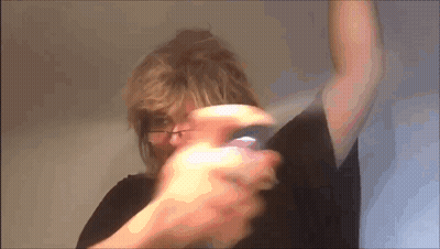Woman Wearing Glasses Holding Purple Object GIF