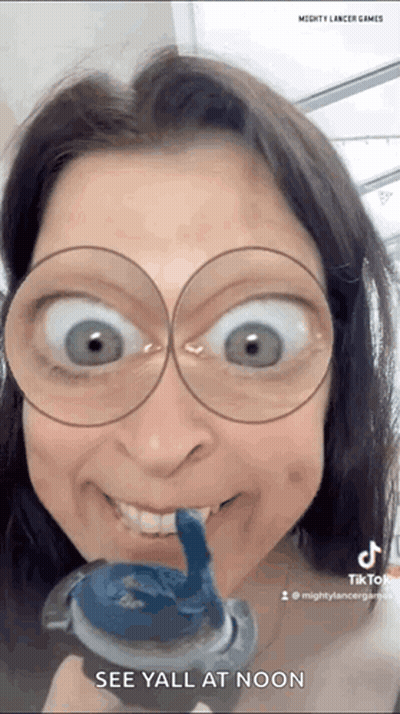 Woman Wearing Glasses Holding Toothpaste GIF