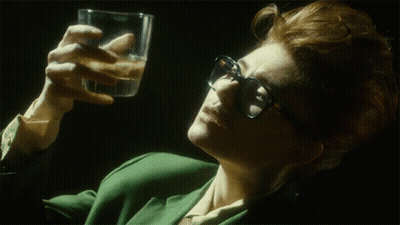 Woman Wearing Glasses Holding Water GIF