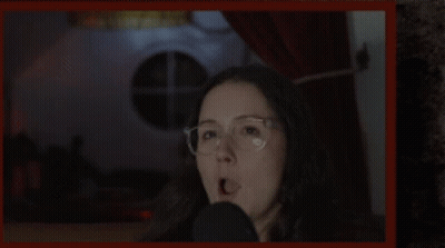 Woman Wearing Glasses Talking Into Microphone GIF