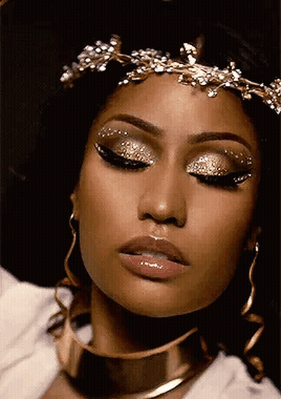 Woman Wearing Gold Crown And Earrings GIF