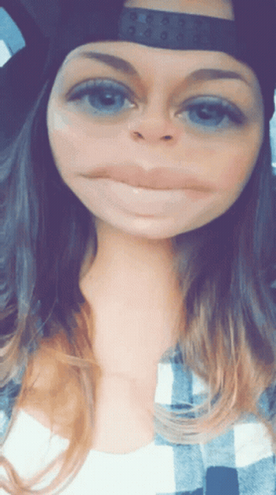 Woman Wearing Hat And Plaid Shirt Making Face GIF