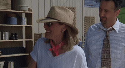 Woman Wearing Hat Next To Man GIF