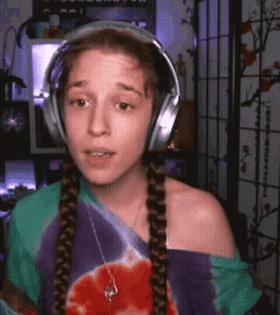 Woman Wearing Headphones And Tie Dye Shirt GIF