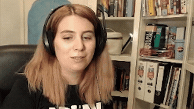 Woman Wearing Headphones In Front Of Bookshelf GIF