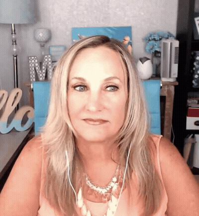 Woman Wearing Headphones In Front Of Love Sign GIF