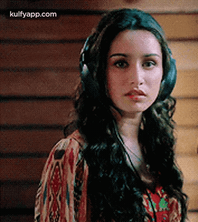 Woman Wearing Headphones Looking At Camera GIF