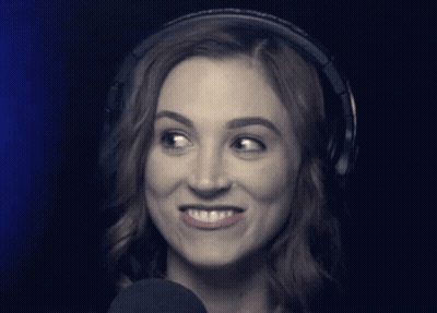 Woman Wearing Headphones Looks At Camera GIF