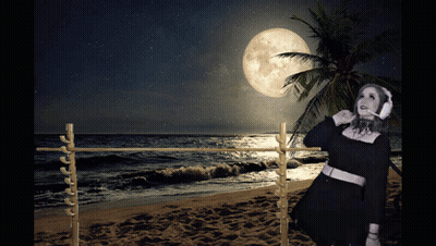 Woman Wearing Headphones On Beach At Night GIF