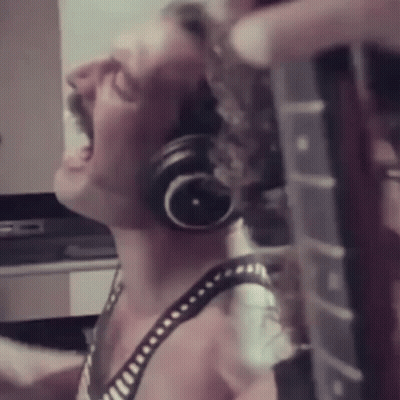 Woman Wearing Headphones Playing Guitar GIF