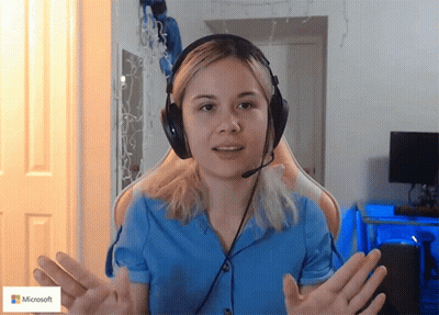 Woman Wearing Headphones Sitting Beside Microsoft Sign GIF