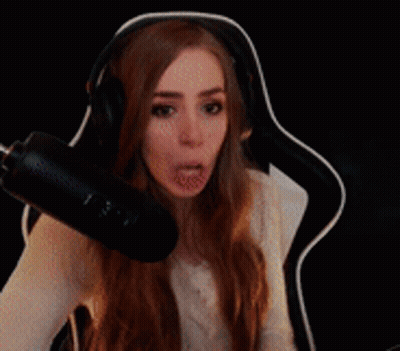Woman Wearing Headphones Sitting in Front of Microphone