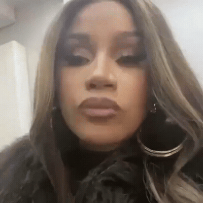 Woman Wearing Hoop Earrings And Fur Coat Making Funny Face GIF