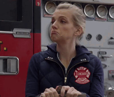 Woman Wearing Jacket That Says Fire Chicago Paramedic GIF