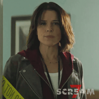 Woman Wearing Leather Jacket And Scream Lanyard GIF