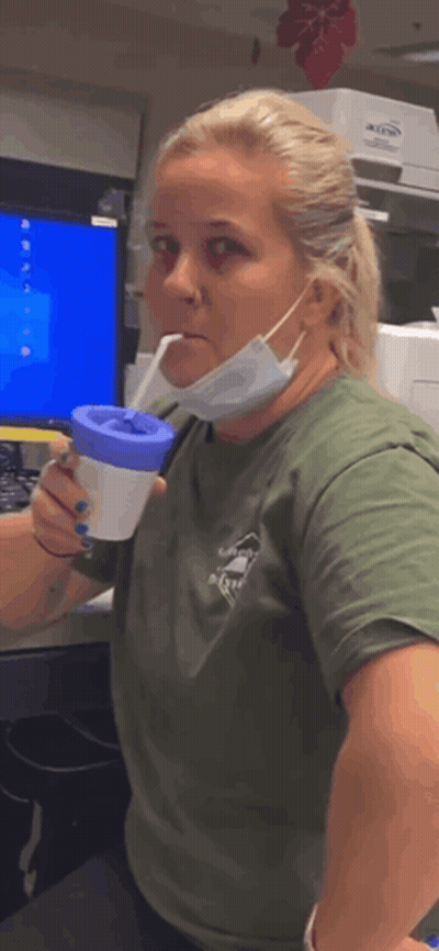 Woman Wearing Mask Holding Cup GIF