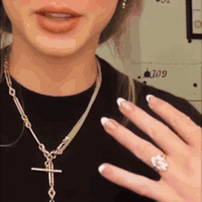 Woman Wearing Necklace And Ring GIF