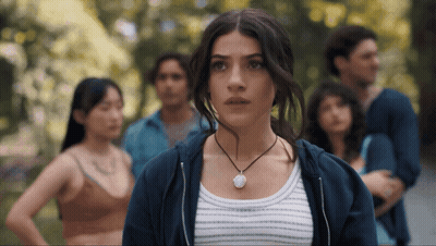 Woman Wearing Necklace In Front Of Crowd GIF