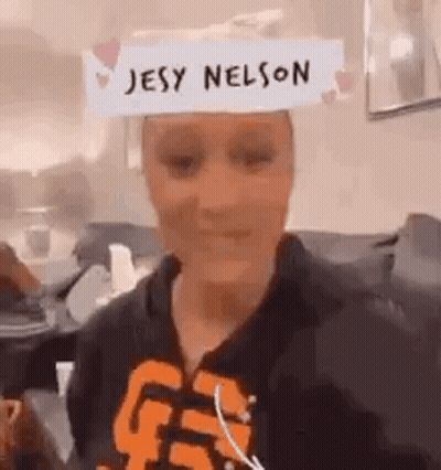 Woman Wearing Paper Hat Saying Jesy Nelson GIF