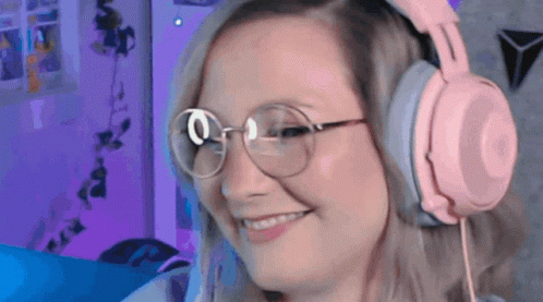 Woman Wearing Pink Headphones And Glasses Smiling GIF