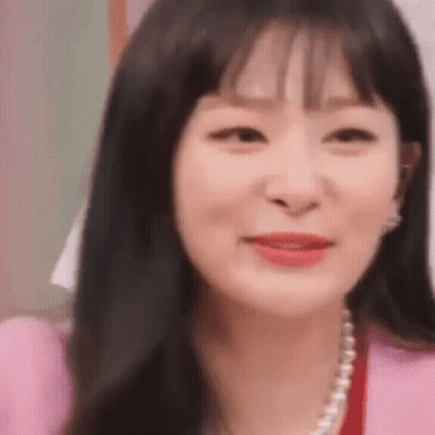 Woman Wearing Pink Jacket And Pearls GIF