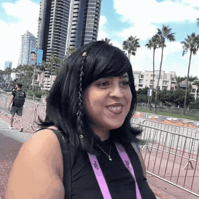 Woman Wearing SDCC Lanyard Smiling GIF