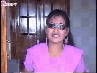 Woman Wearing Sunglasses And Earrings Smiling GIF