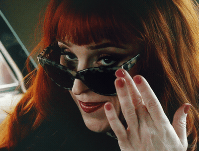 Woman Wearing Sunglasses And Red Nail Polish GIF