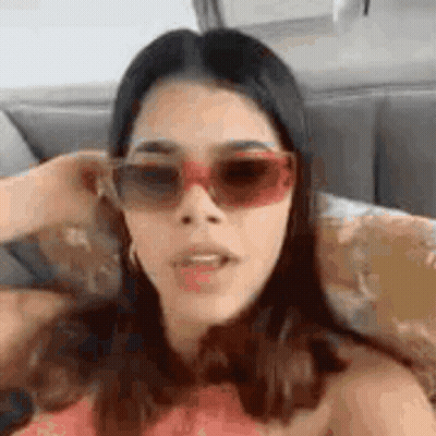 Woman Wearing Sunglasses Making Funny Face GIF