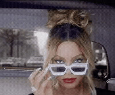 Woman Wearing Sunglasses Talking On Phone GIF