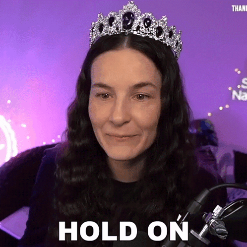 Woman Wearing Tiara Saying Hold On At Microphone GIF