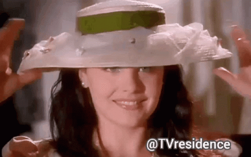 Woman Wearing White Hat With Green Ribbon Smiling GIF