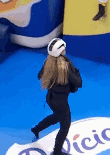 Woman Wearing White Helmet Standing On Blue Floor GIF