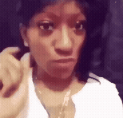 Woman Wearing White Shirt And Gold Necklace Making Face GIF