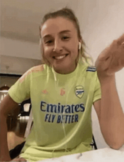 Woman Wearing Yellow Emirates Fly Better Shirt GIF