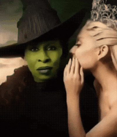 Woman Whispering Into Witch's Ear GIF