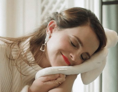Woman White Sweater Hand On Face Eyes Closed GIF