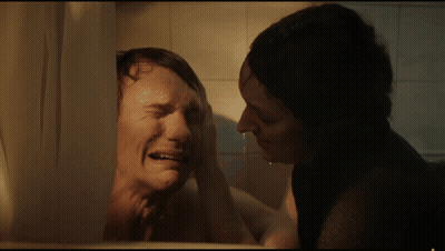 Woman Wiping Man's Face In Bathroom GIF