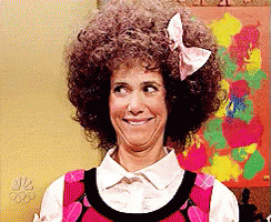 Woman With Afro And Bow Making Funny Face GIF