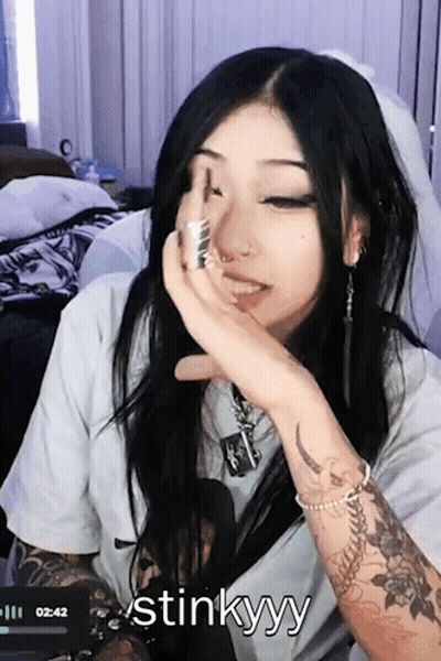 Woman With Arm Tattoo Saying Stinkyy GIF