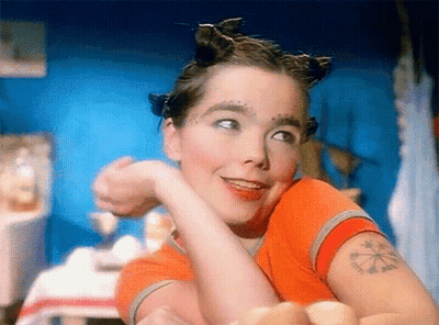 Woman With Arm Tattoo Smiling At Camera GIF