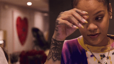 Woman With Arm Tattoo Wiping Eyes GIF