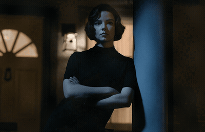 Woman With Arms Crossed Leaning Against Pole GIF