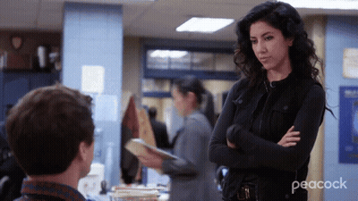 Woman With Arms Crossed Next To Man In Peacock Ad GIF