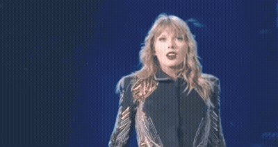 Woman With Arms Outstretched In Sequin Jacket GIF