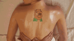 Woman With Back Tattoo Having Sensual Massage