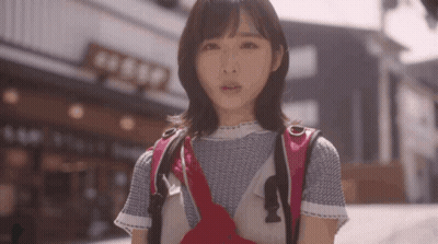 Woman With Backpack In Front Of Building Saying Aeep GIF