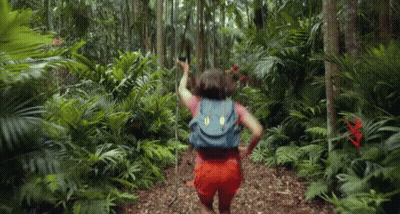 Woman With Backpack Walking Through Jungle GIF